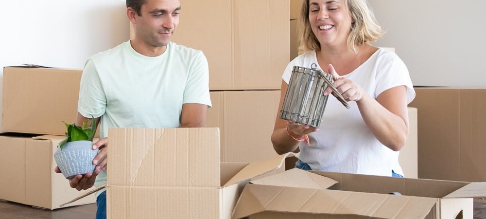 Cheerful married couple moving into new apartment